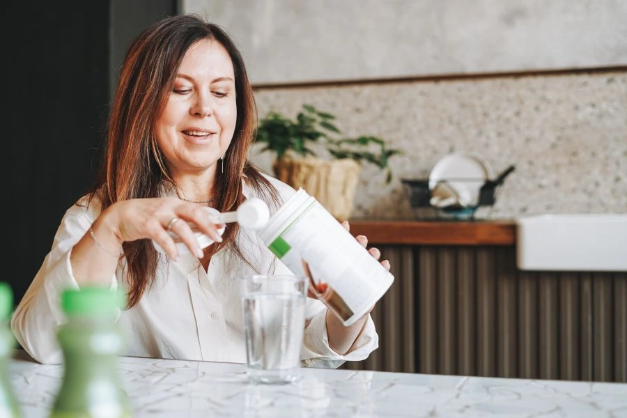 Woman making whey protein drink